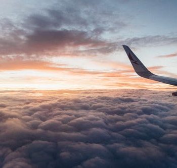 White Airliner Wing on Top of Sea Clouds