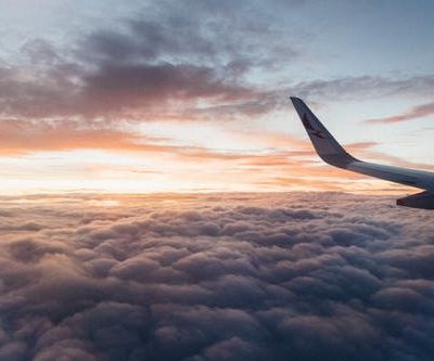 White airliner wing on top of sea clouds 5 best apps for your first travel