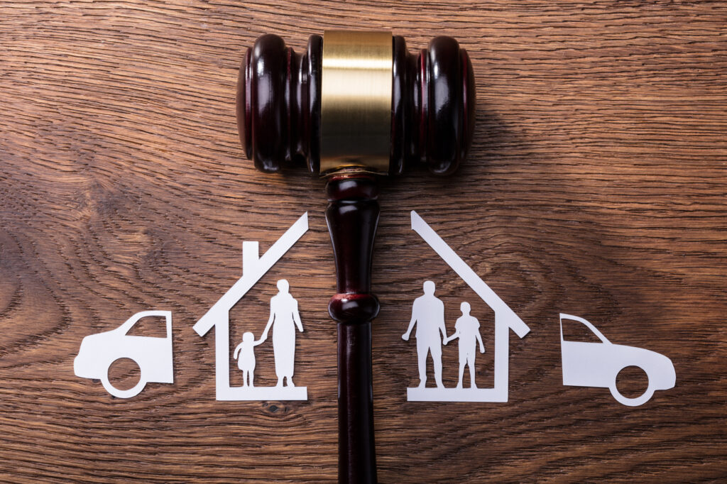 Judge Mallet Between the Split Paper Cutout Family and Car dividing the family home in a divorce