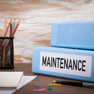 Maintenance Office Binder on Wooden Desk on the Table Colored why equipment performance evaluations are important