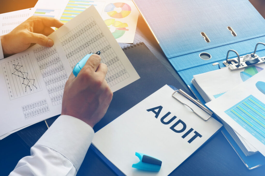Document with Title Audit on an Office Table the brief guide that makes conducting a financial audit simple