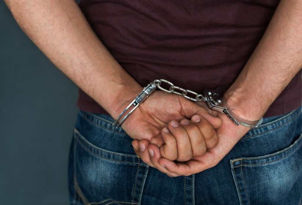 Caucasian Male Arrested and with Handcuffs the different types of assault and battery charges that exist today