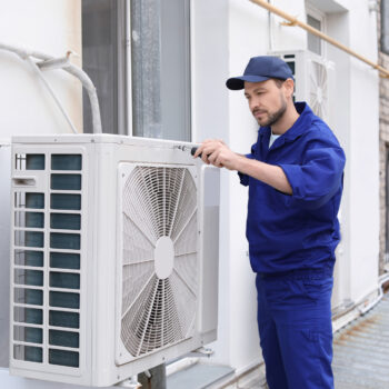 Male Technician Repairing Air Conditioner Outdoors hvac issues 4 major signs your hvac is on the fritz