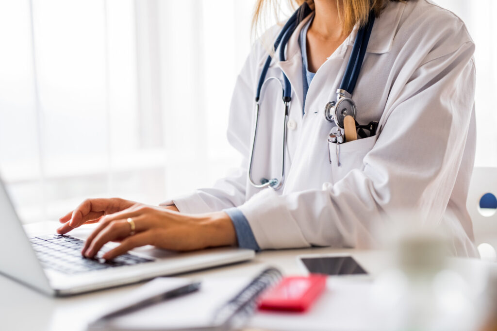 Female Doctor with Laptop Working at the Office Desk 5 vital pieces of equipment every medical practice needs