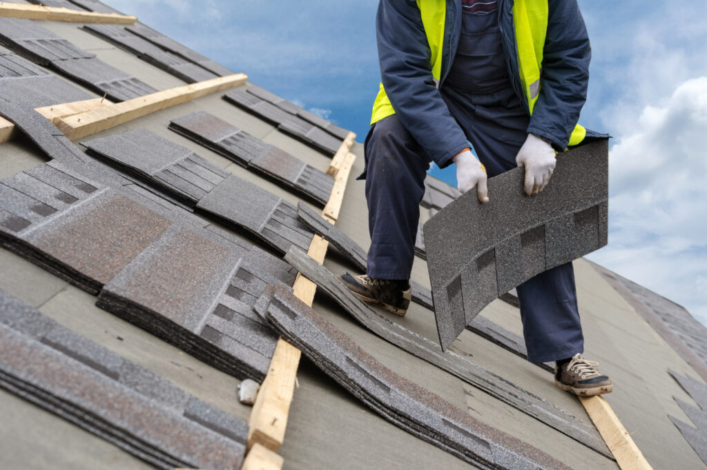 Workman Install Tile on Roof of New House Under Construction roof replacement or repairs which do i need