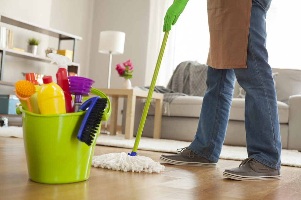 Man Holding Mop and Plastic Bucket how to keep your house clean without extra effort