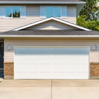 Wide Garage Door of Residential House with Concrete Driveway in Front the benefits of automatic garage doors