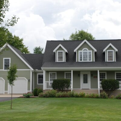 white and gray house near green grass field