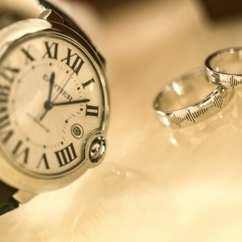 A watch and wedding rings Description automatically generated